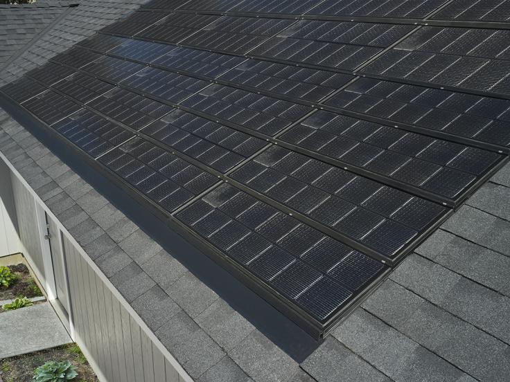 Sleek solar panels on a gray asphalt roof
