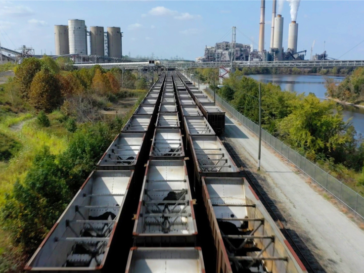 Train tracks lead to a factory setting