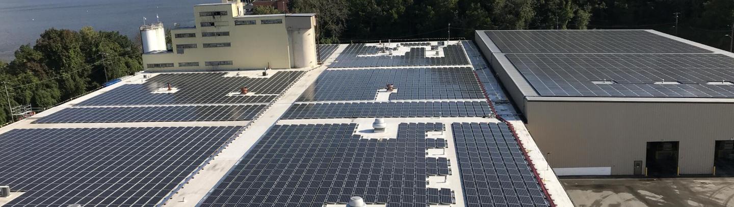 A manufacturing facility has solar panels across the entire roof