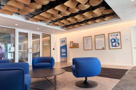 The lobby area for the Malvern Innovation Center features CertainTeed's Petals as a ceiling treatment. Wooden panels in the shape of petals are attached to the ceiling for acoustic performance.