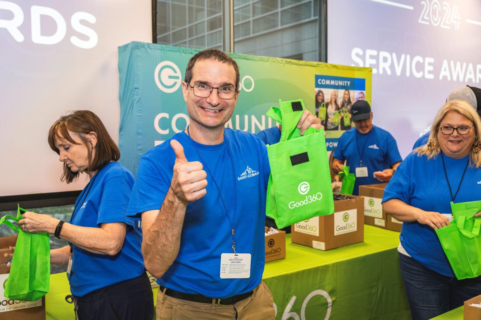 Man giving a thumbs up holding a Good360 hygiene kit