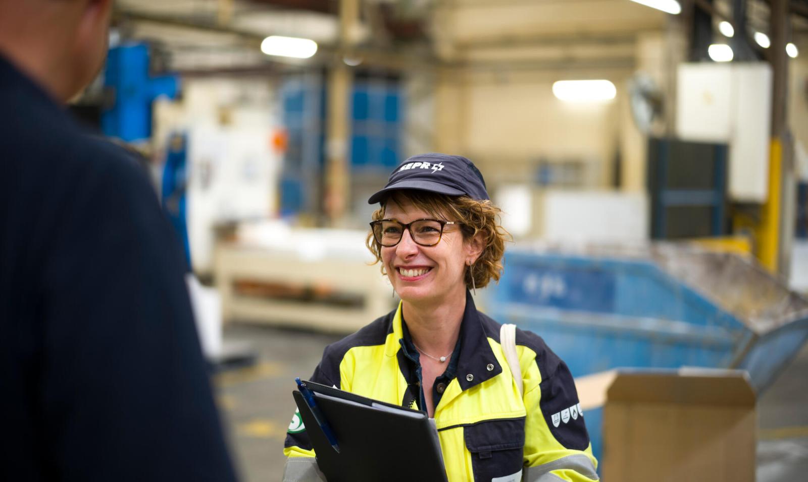A close-up of female employee at Saint-Gobain  with a rewarding manufacturing career at Saint-Gobain North America on the plant floor.