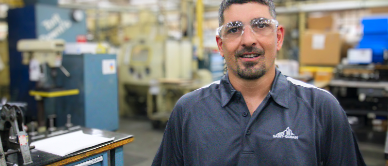 Man in safety glasses at Saint-Gobain North America’s facility representing a production operator job in manufacturing.